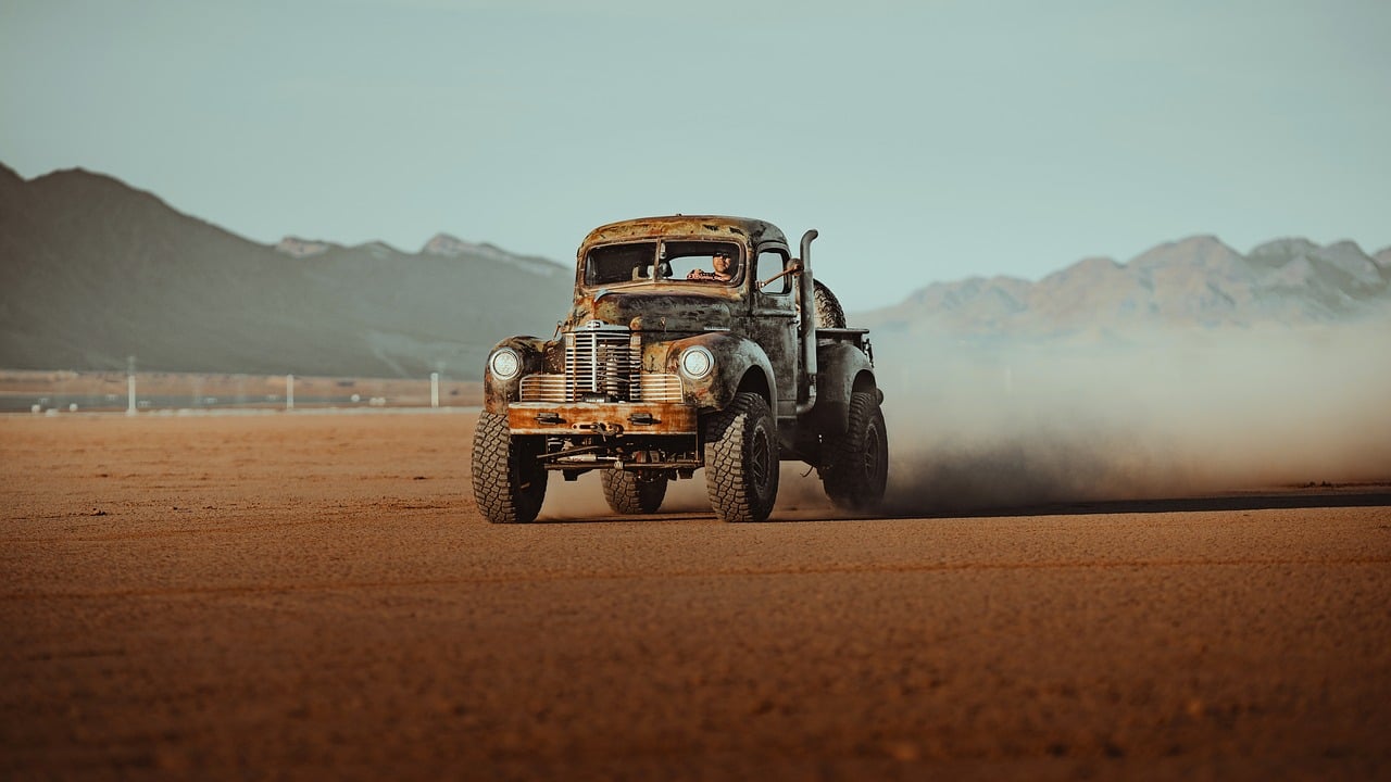 Truck driving through sand